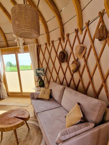 a living room with a couch and a table at Osada JurtCamp w Witowie in Witówko