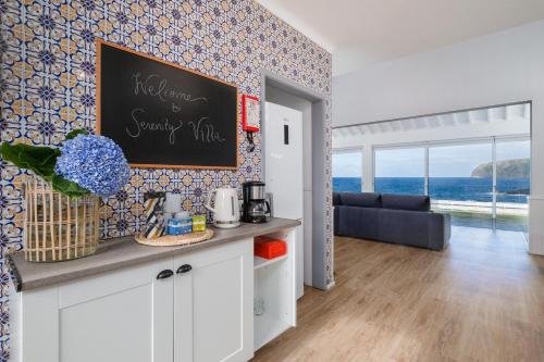 a kitchen with a chalk board on a wall at Serenity Villa in Mosteiros