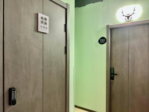 an elevator with a door in a room at East Coast Coffee Inn in Xi'an
