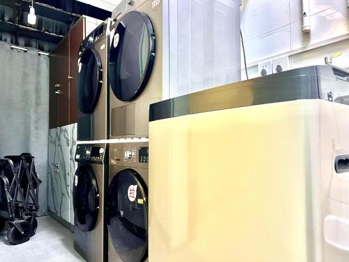 a row of washing machines in a laundry room at East Coast Coffee Inn in Xi'an
