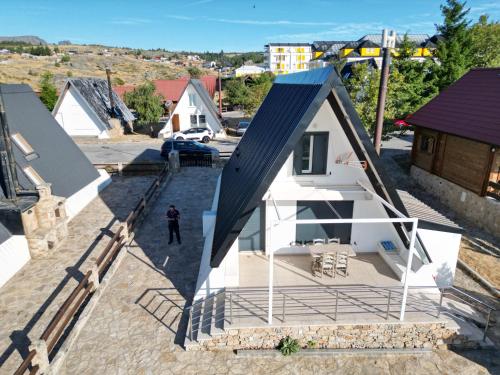 a small white house with a black roof at Bungalow QJ in Covilhã