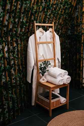 a wooden towel rack with towels and towels at Kallias Dome Resort in Sovata
