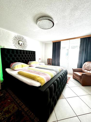 a bedroom with a large bed and a couch at Haus Mantai in Freudenstadt