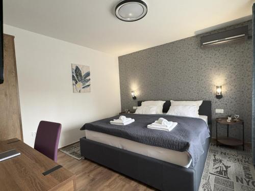 a bedroom with a large bed in a room at APOLLO - Center - Self check in - free parking in Osijek