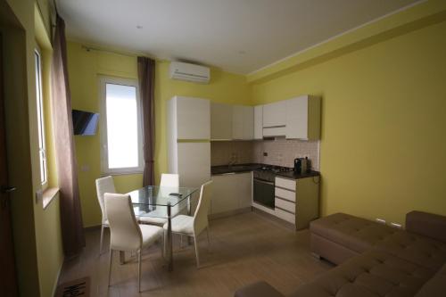 a kitchen and dining room with a glass table and chairs at Sweet Monte Verde in Rome