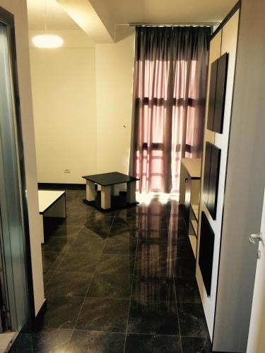 a room with a table in front of a window at Herges Hotel in Durrës