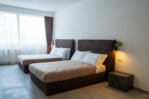 Postel nebo postele na pokoji v ubytování Hotel Bulà