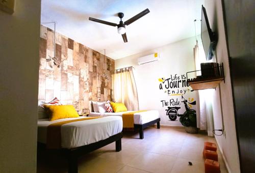 a room with two beds and a couch in it at Alberca-Privacidad-Confort in Mérida