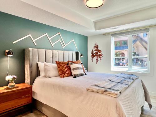 a bedroom with a large bed with a snowy wall at Special! New Downtown Mtn View Free Parking 2b&2b in Canmore