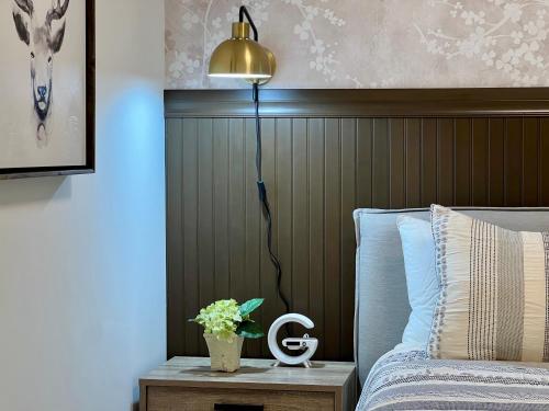 a bedroom with a bed and a lamp on a table at Special! New Downtown Mtn View Free Parking 2b&2b in Canmore