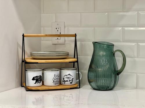 a shelf with plates and a vase on a counter at Special! New Downtown Mtn View Free Parking 2b&2b in Canmore