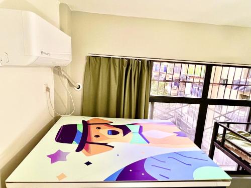 a bed with a painting of a horse on it at East Coast Coffee Inn in Xi'an