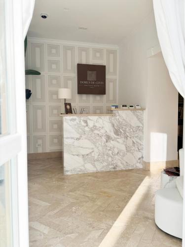 a marble counter in a room with a television on a wall at Domus De Cinti Boutique Rooms in Tivoli