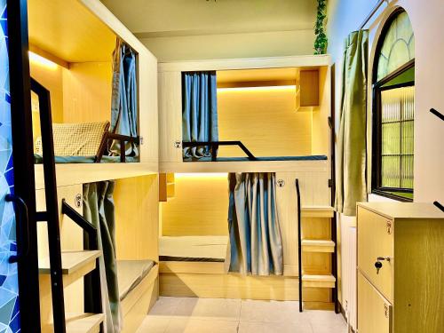 a room with bunk beds with a window at East Coast Coffee Inn in Xi'an