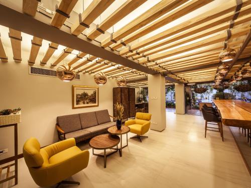 a living room with a couch and chairs and a table at Metro Pratunam Boutique Hotel in Pratunam