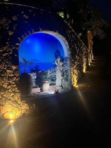a statue of a woman in an archway at night at Casa Vacanze Chery in Sorrento