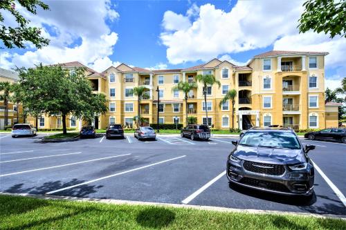 a parking lot in front of a large building at Vista Cay Resort by Millenium at Universal Blvd. in Orlando