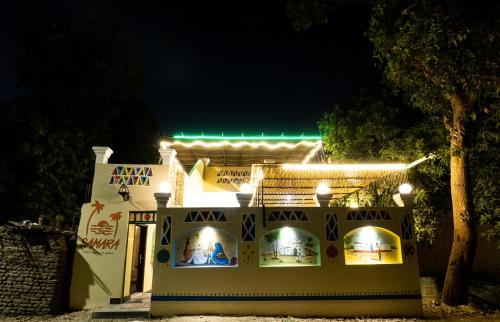 a white building with lights on it at night at Samara Guest House in Aswan