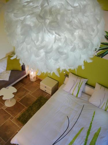 a bedroom with a bed with a large white cloud overhead at La Bastide Des Selves in Draguignan