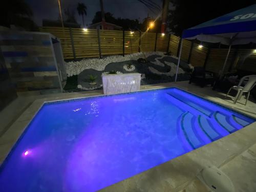 a swimming pool at night with blue lighting at Casa Chela in Rincon