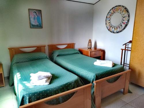 two twin beds in a room with a mirror at Holiday Residence in Casamassima