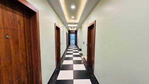 a hallway with a black and white checkered floor at Atalchhatra Luxury Boutique Hotel in Jaipur