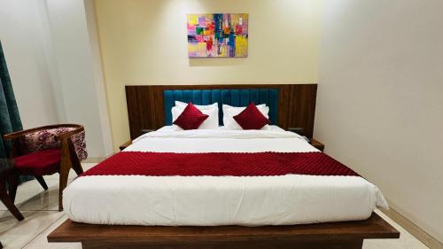 a bedroom with a large bed with red pillows at Atalchhatra Luxury Boutique Hotel in Jaipur