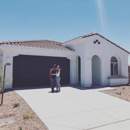 a man and woman standing in front of a garage at Sosegado at The Parks in Queen Creek