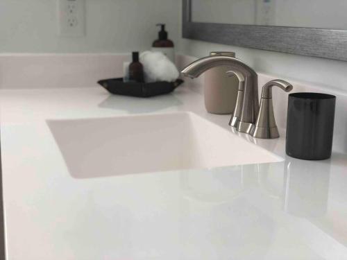 a white kitchen counter with a sink and a sink at Sosegado at The Parks in Queen Creek