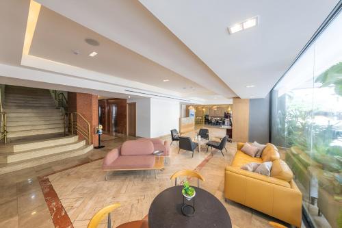 a lobby with a couch and chairs and a table at Hotel Faranda Express Soloy and Casino, a member of Radisson Individuals in Panama City