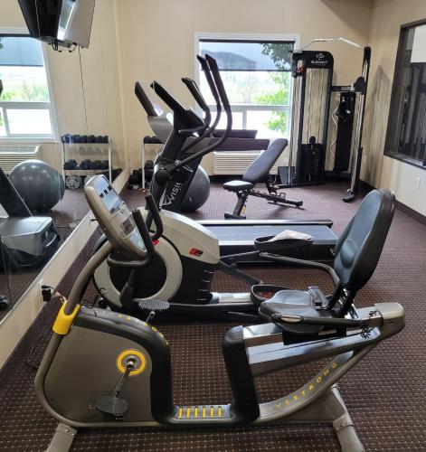 a gym with several exercise bikes in a room at The Kanata Bonnyville in Bonnyville