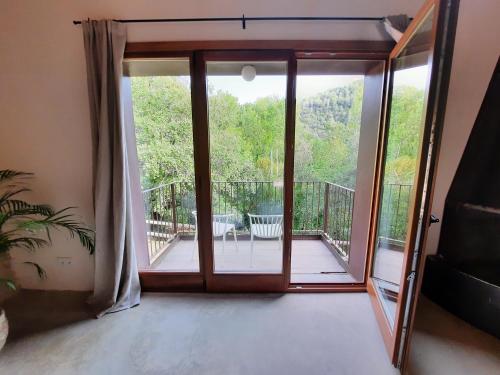 a room with a sliding glass door leading to a balcony at Mas Nou in Albanya
