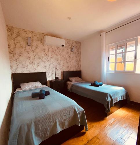 a bedroom with two beds and a window at Casa Cesar in Puntagorda