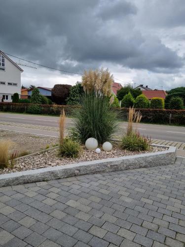 a landscaping with rocks and plants on a street at Ferienwohnung Illertal in Unteropfingen