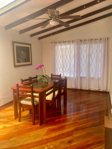 a dining room table with chairs and a ceiling fan at Entire Holiday Home in Shell