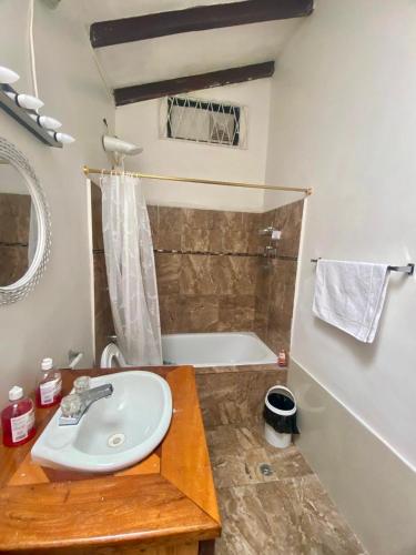 a bathroom with a sink and a bath tub at Entire Holiday Home in Shell