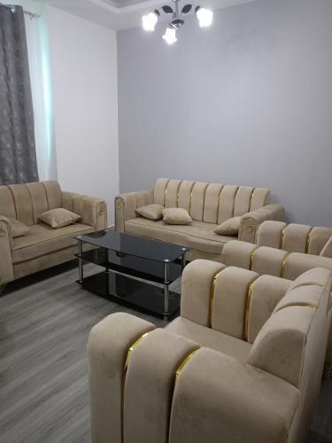 a waiting room with couches and chairs and a table at City Towers in Ajman 