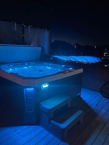 a hot tub on a deck at night at Loox Ostrovo- Boutique House-noclegi nad morzem in Ostrowo