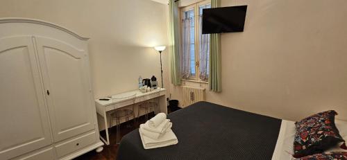 a bedroom with a bed and a sink and a window at il Sole di Baggio in Milan