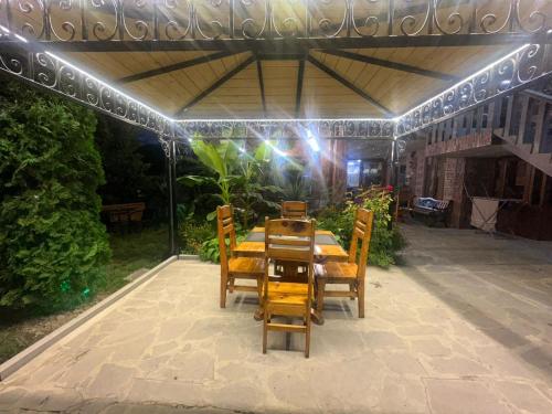 a table and chairs under a pergola on a patio at Colibri Hotel in Haghpat