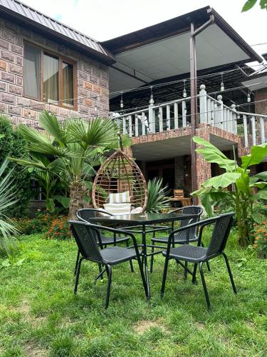 a table and chairs in front of a house at Colibri Hotel in Haghpat