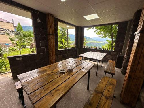 a room with a wooden table and two benches at Colibri Hotel in Haghpat