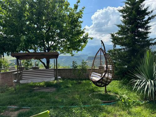 a swing in a yard with a gazebo at Colibri Hotel in Haghpat