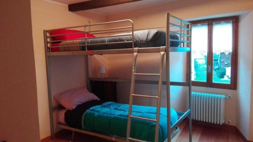 a bunk bed with a ladder next to a room at Il Borgo Di Monica in Domodossola