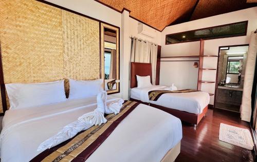 a hotel room with two beds and a window at Lamai Bayview Boutique Resort in Lamai