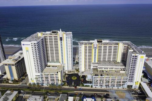 a group of tall white buildings next to the ocean at Penthouse Beach Villa Ocean Walk Resort Daytona in Daytona Beach