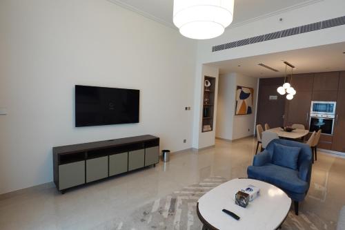 a living room with a flat screen tv on a wall at Address Residence Bahrain in Rayyā