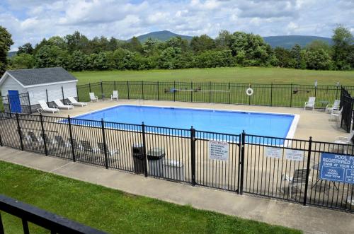 a swimming pool with a fence around it at Days Inn by Wyndham Luray Shenandoah in Luray