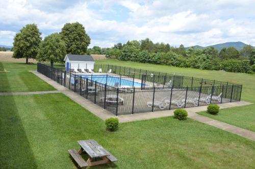 a fence around a swimming pool in a yard at Days Inn by Wyndham Luray Shenandoah in Luray