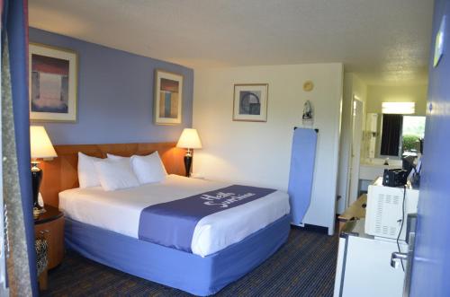 a bedroom with a large bed in a hotel room at Days Inn by Wyndham Luray Shenandoah in Luray